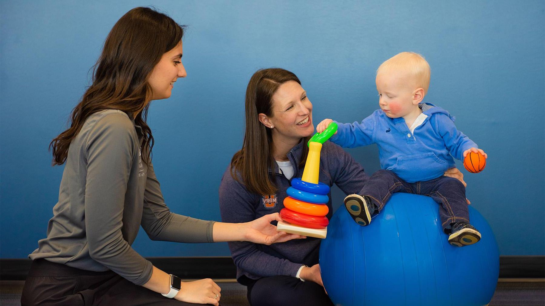 Physical therapy student working with a child